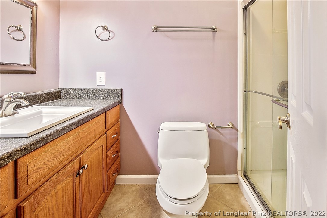 595 Winding Creek Road, Unit B Fayetteville, NC 28305 - Photo 11 of 17 a white toilet sitting next to a bathroom sink