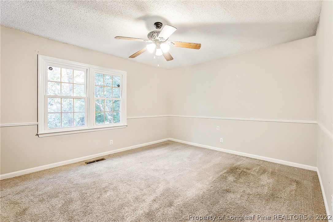 595 Winding Creek Road, Unit B Fayetteville, NC 28305 - Photo 13 of 17 an empty room with windows and fan