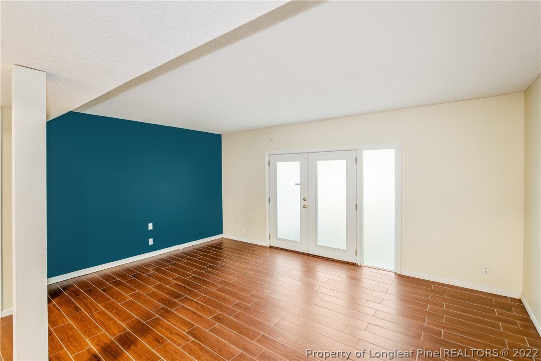 595 Winding Creek Road, Unit B Fayetteville, NC 28305 - Photo 3 of 17 a view of a room with an empty space and wooden floor