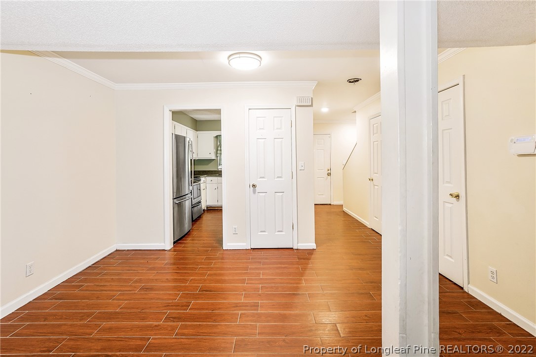 595 Winding Creek Road, Unit B Fayetteville, NC 28305 - Photo 4 of 17 a view of a hallway with wooden floor and staircase