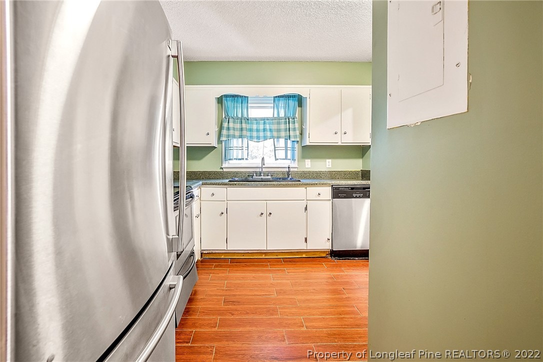 595 Winding Creek Road, Unit B Fayetteville, NC 28305 - Photo 5 of 17 a kitchen with granite countertop a sink and a stove