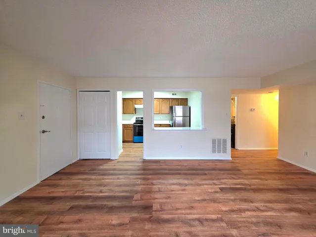 a kitchen with stainless steel appliances granite countertop a refrigerator a sink dishwasher a stove with wooden cabinets