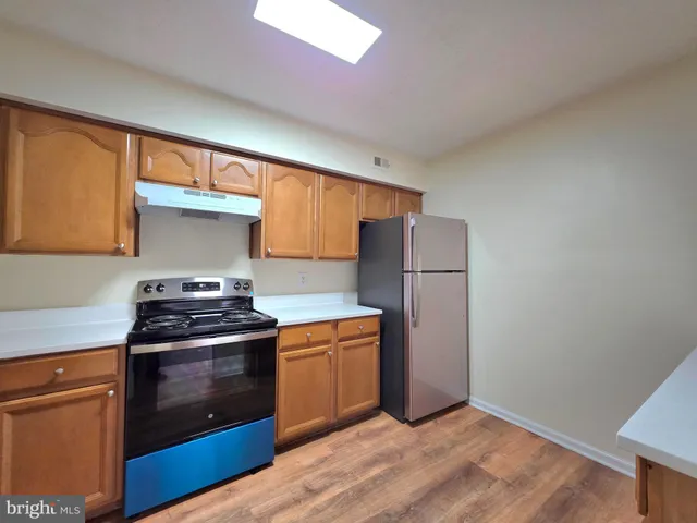 a kitchen with a sink cabinets and stainless steel appliances