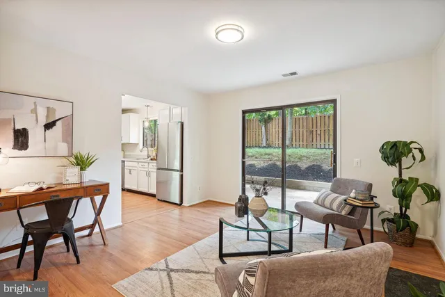 a living room with furniture a table and a potted plant