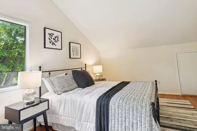 a bedroom with a bed and a night stand