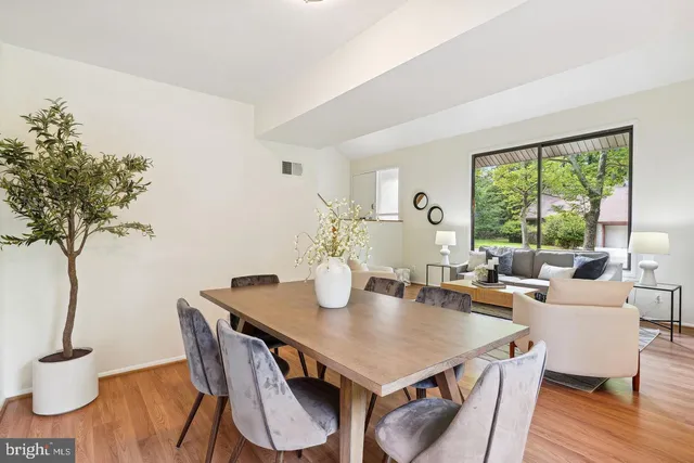 a view of a dining room with furniture window and wooden floor