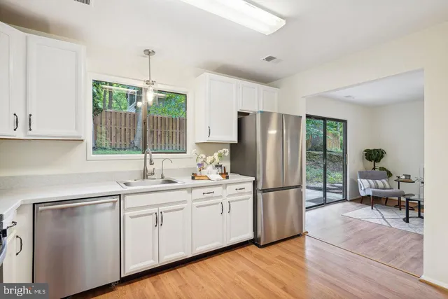 a kitchen with a sink appliances and cabinets