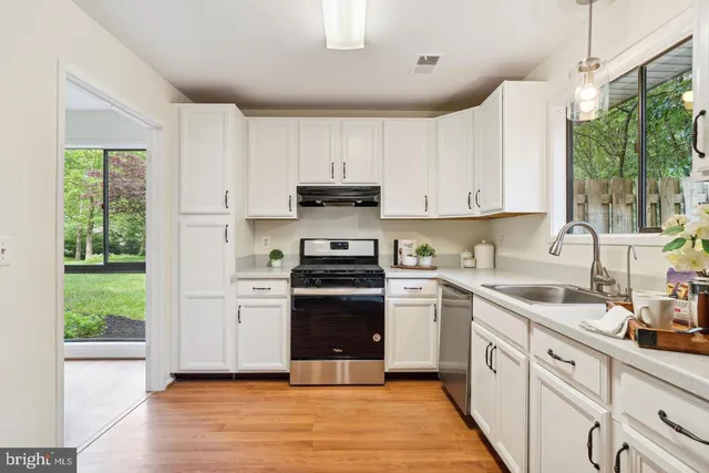 a kitchen with a sink stove and cabinets