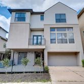 a view of a brick house with large windows