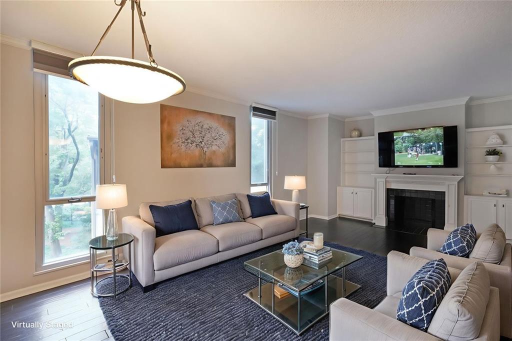 3060 Pharr Road Northwest, Unit 114 Atlanta, GA 30305 - Photo 5 of 16 a living room with furniture a fireplace and a window