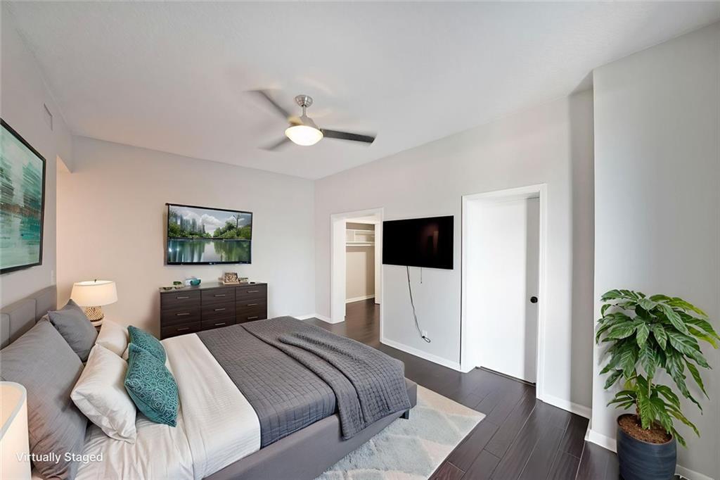 3060 Pharr Road Northwest, Unit 114 Atlanta, GA 30305 - Photo 8 of 16 a bedroom with a bed and a chandelier