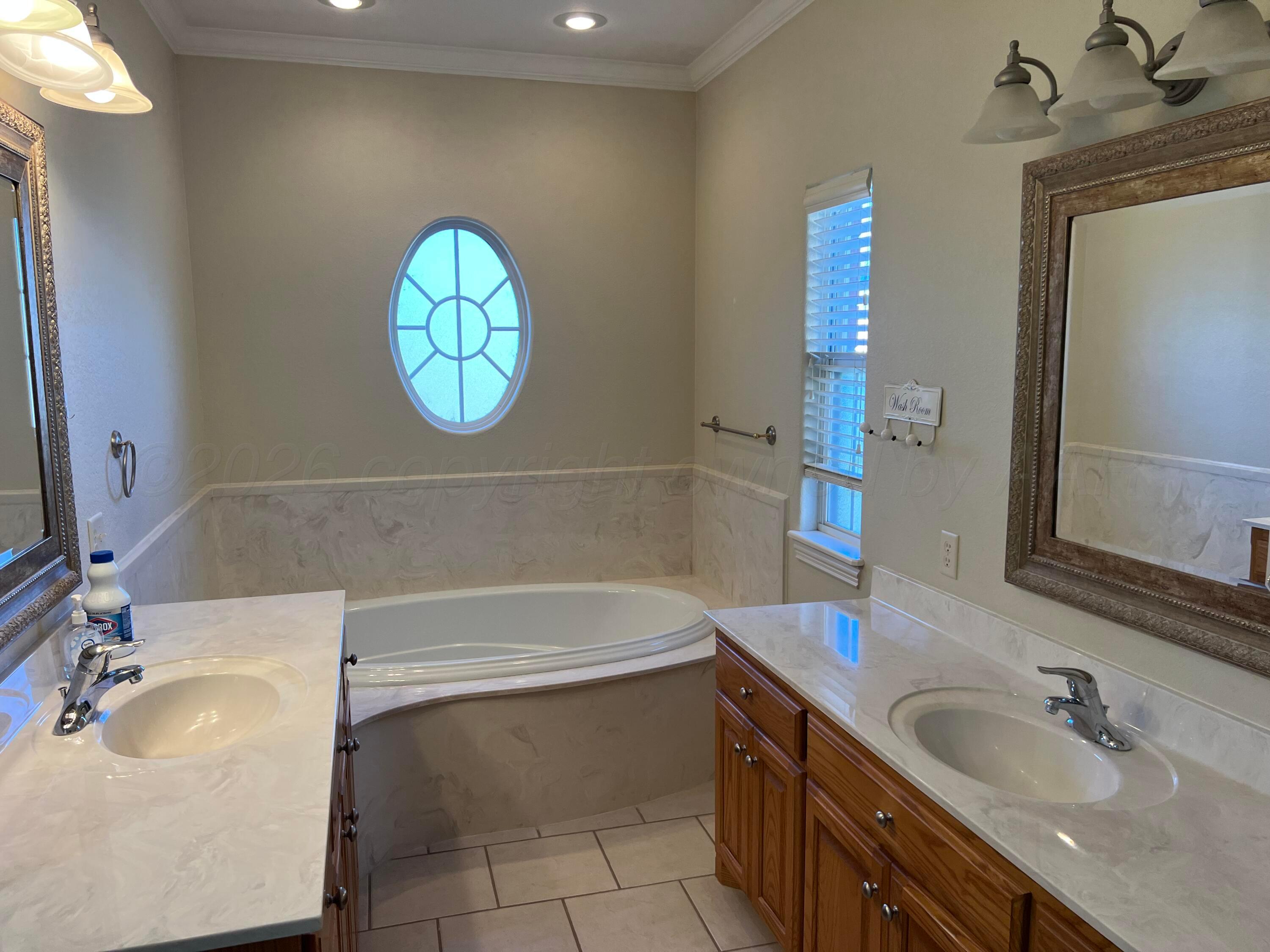 8405 Addison Drive Amarillo, TX 79119 - Photo 11 of 18 a bathroom with a sink and a mirror