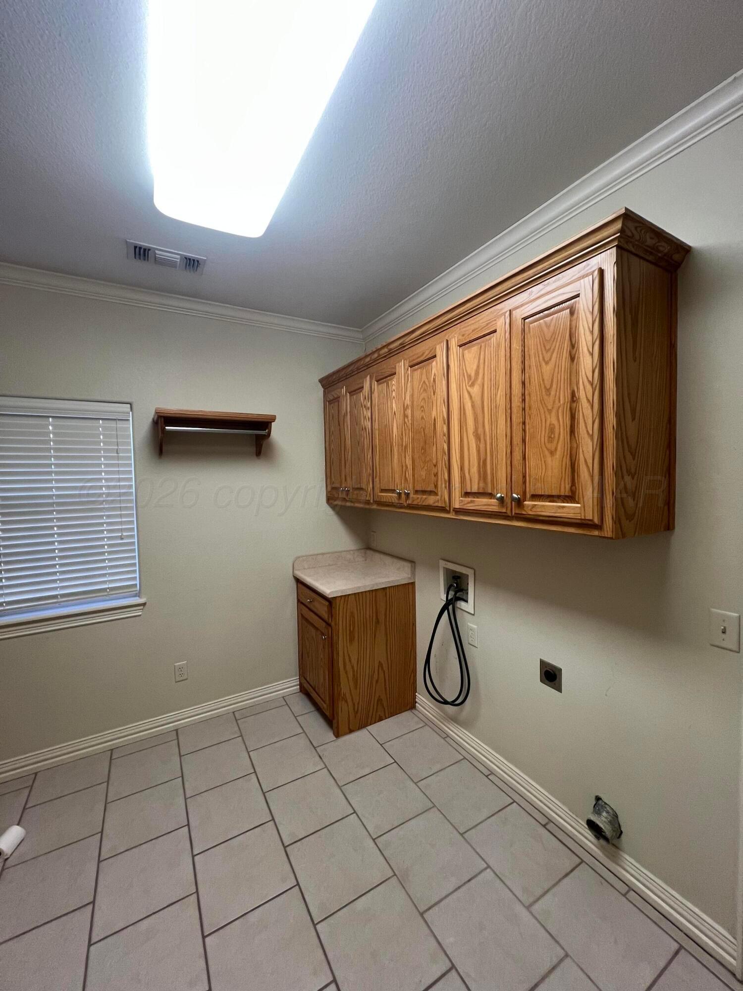 8405 Addison Drive Amarillo, TX 79119 - Photo 13 of 18 a room with a wooden floor and white walls