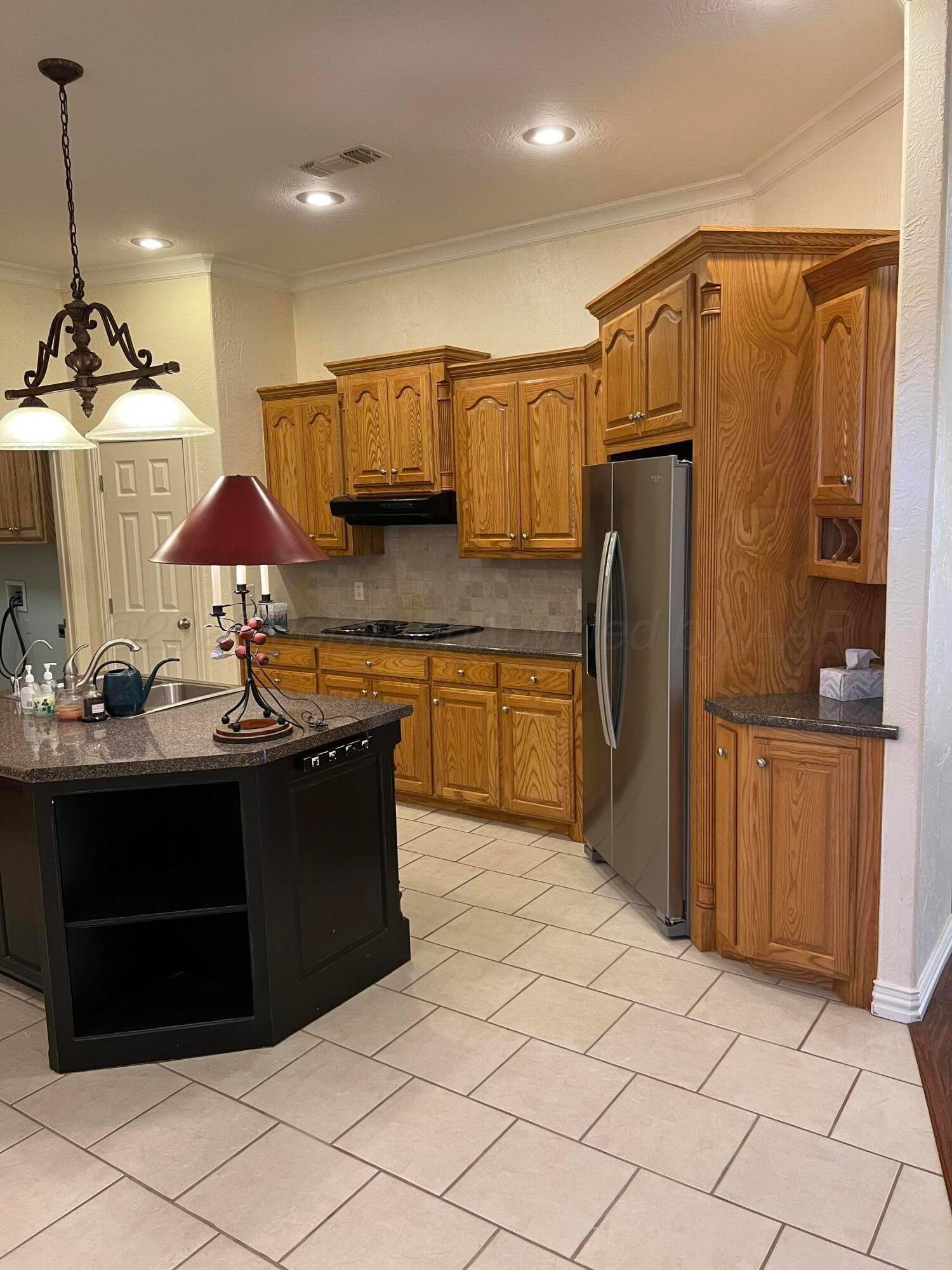 8405 Addison Drive Amarillo, TX 79119 - Photo 3 of 18 a kitchen with stainless steel appliances a sink and a refrigerator