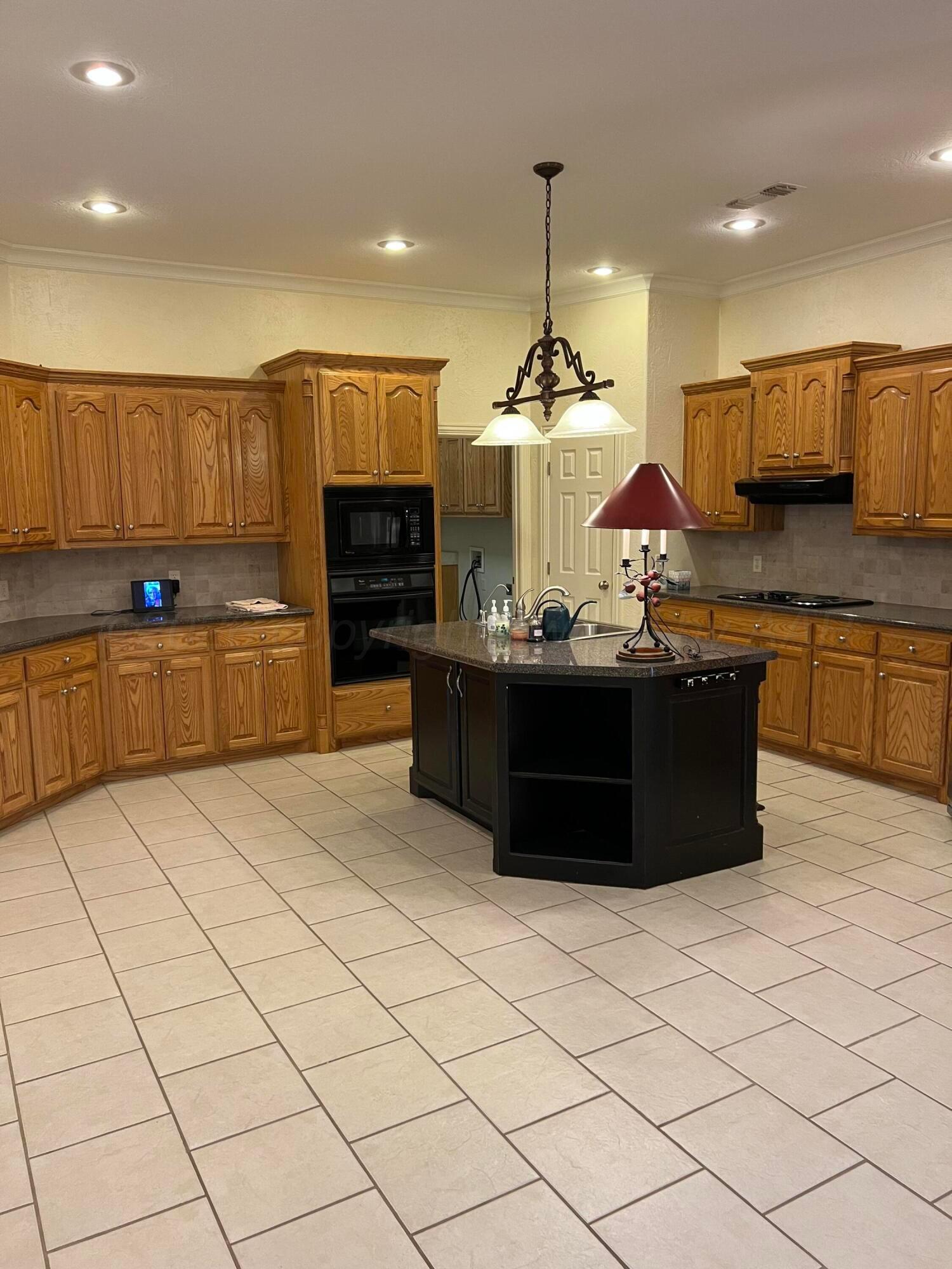 8405 Addison Drive Amarillo, TX 79119 - Photo 5 of 18 a kitchen with stainless steel appliances granite countertop a sink and a stove