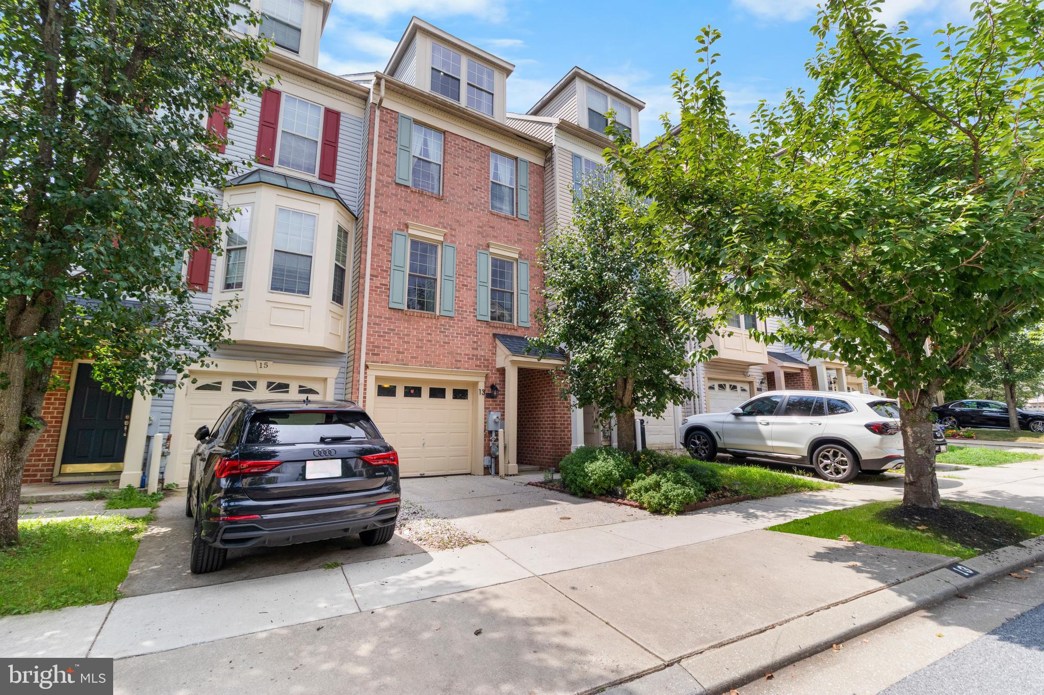 13 Bank Spring Court Owings Mills, MD 21117 - Photo 2 of 50 a car parked in front of a brick house