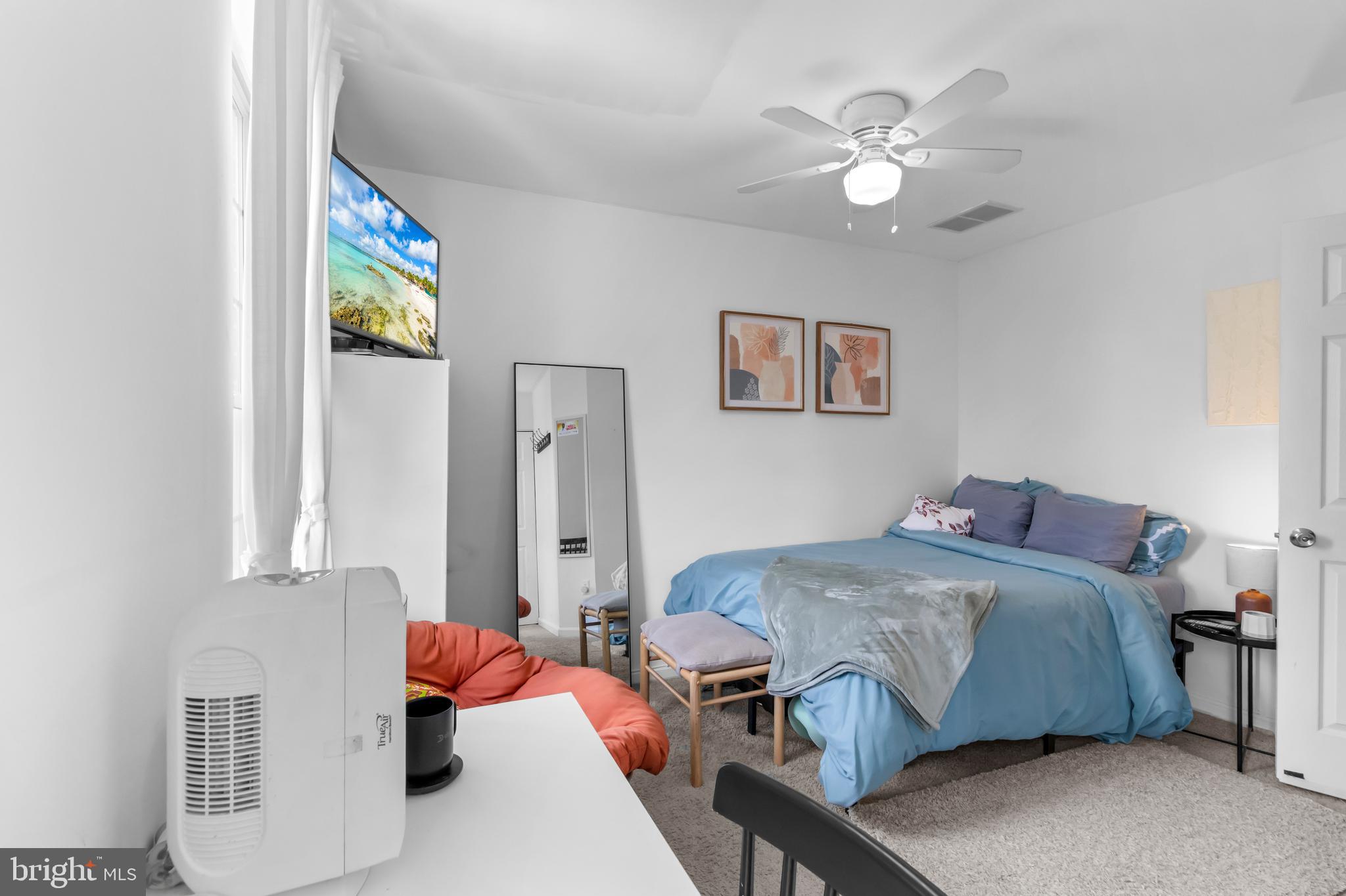13 Bank Spring Court Owings Mills, MD 21117 - Photo 27 of 50 a bedroom with a bed and a chandelier