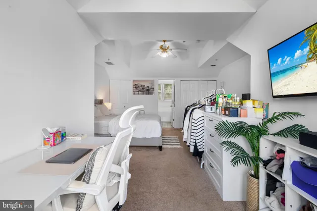 a dining room with furniture and a flat screen tv