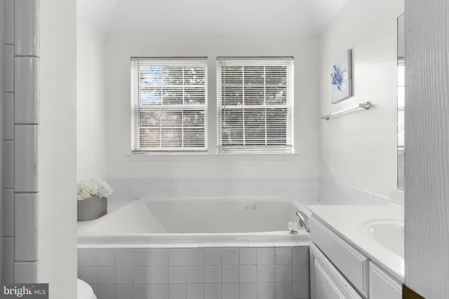 a white bath tub sitting next to a window
