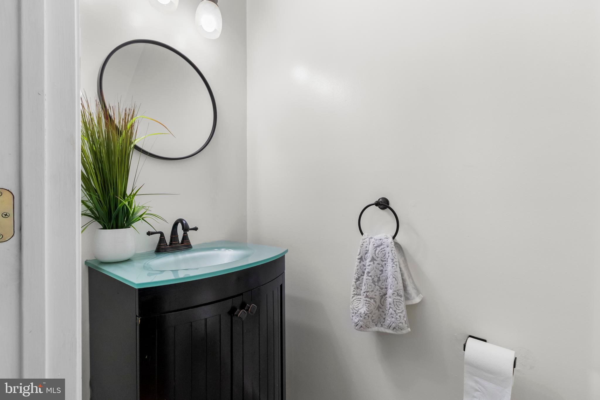 13 Bank Spring Court Owings Mills, MD 21117 - Photo 38 of 50 a bathroom with a sink and a mirror