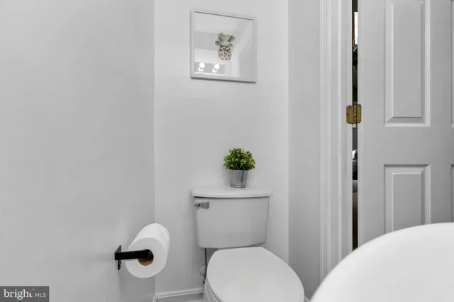 a white toilet sitting next to a bathroom sink