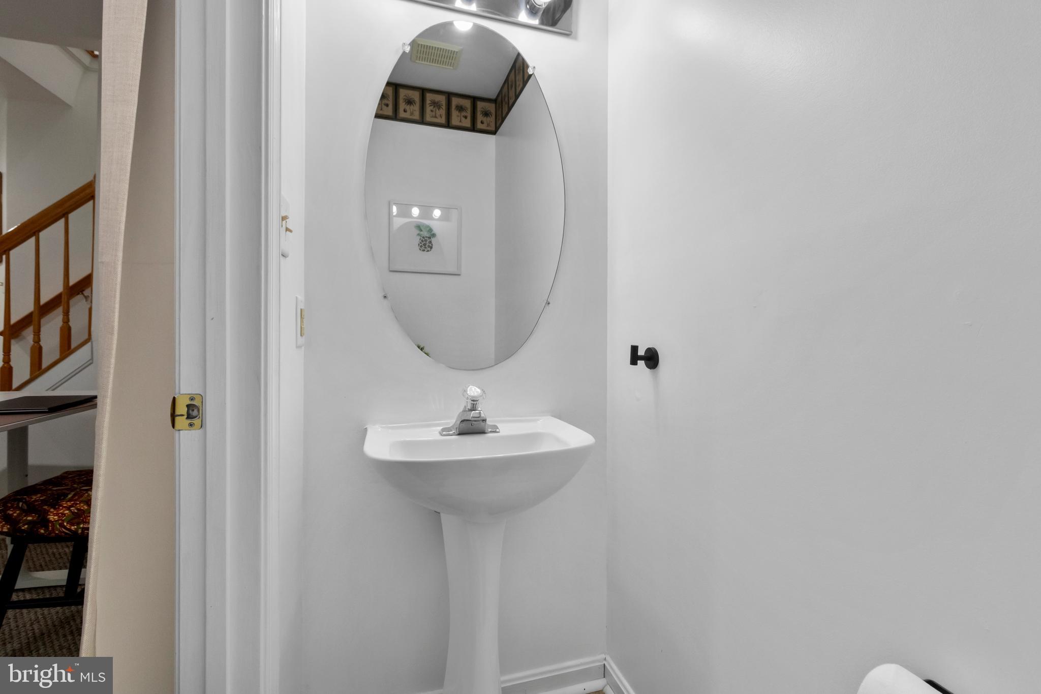 13 Bank Spring Court Owings Mills, MD 21117 - Photo 43 of 50 a bathroom with a sink a mirror and vanity