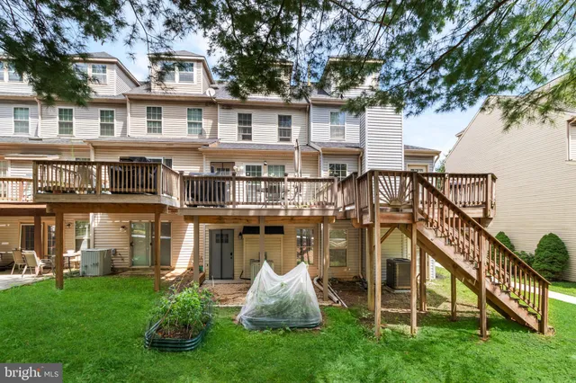 a front view of a house with a yard and staircase