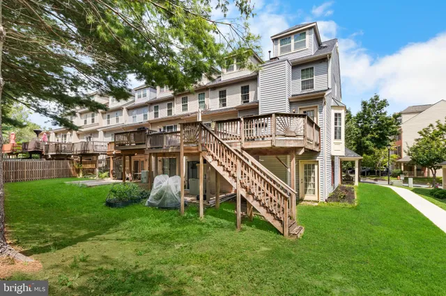 a view of a house with a backyard and a deck