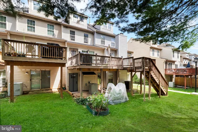 a front view of a house with a yard and deck