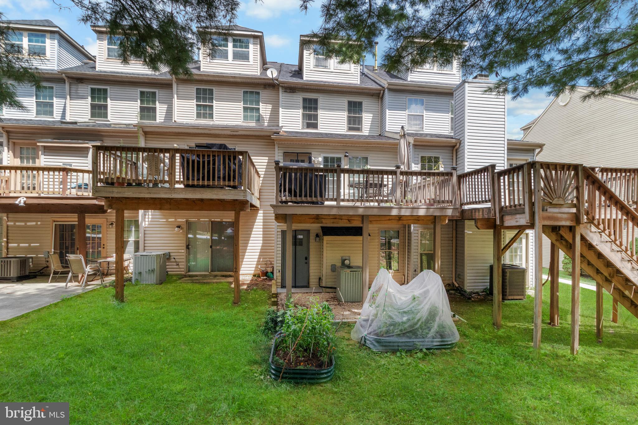 13 Bank Spring Court Owings Mills, MD 21117 - Photo 50 of 50 a front view of a house with a yard and outdoor seating