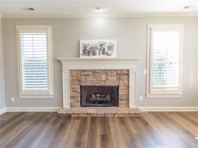 a living room with a fireplace and a window