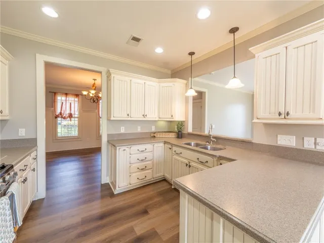 a kitchen with a stove a sink and a refrigerator