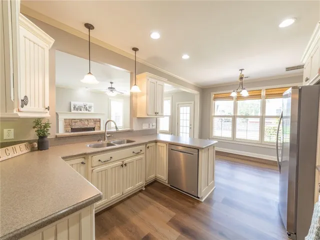 a large kitchen with lots of counter space sink and appliances