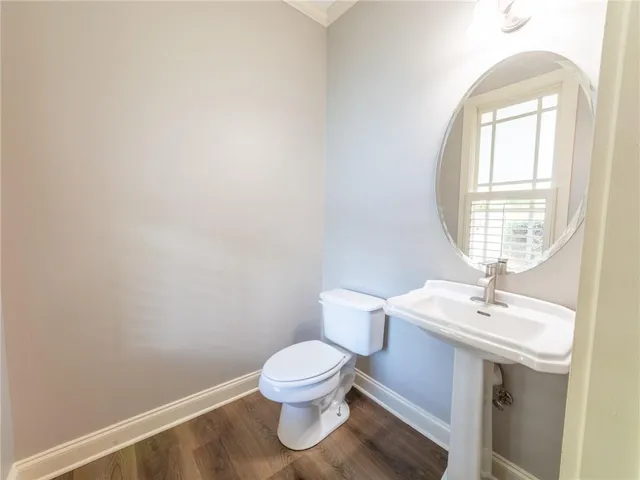 a white toilet sitting next to a bathroom sink