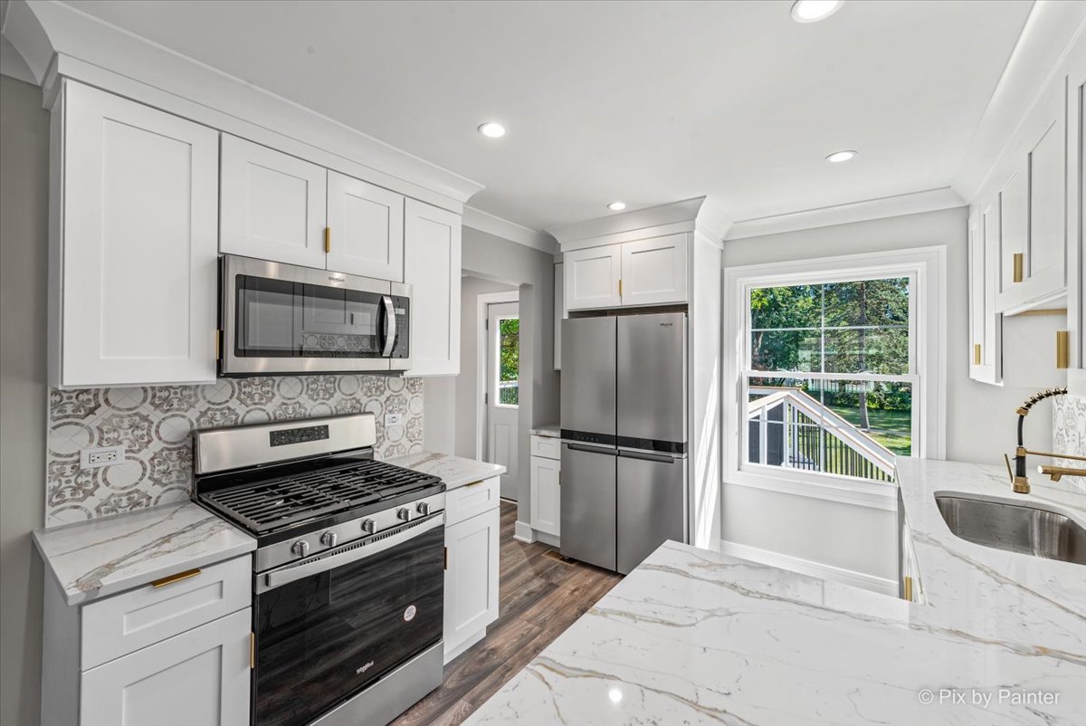 229 West Harding Road Lombard, IL 60148 - Photo 6 of 29 a kitchen with a stove a microwave and a refrigerator