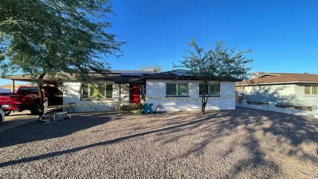a view of a house with sitting area and covered with trees