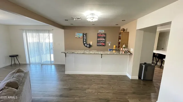 a view of a kitchen with furniture and a wooden floor