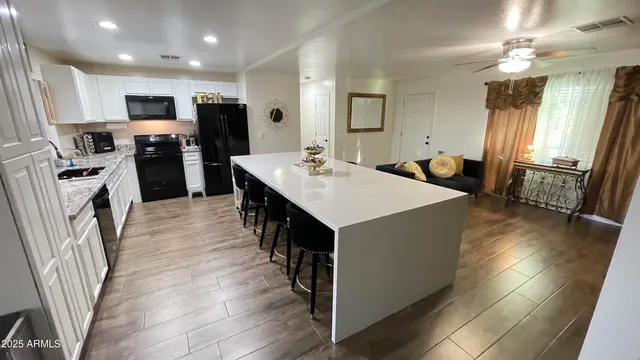 a kitchen with granite countertop a sink appliances and cabinets