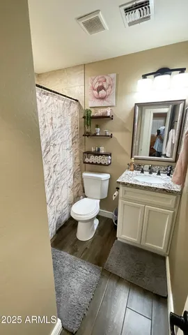 a bathroom with a sink toilet and shower