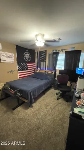 a bedroom with a bed and a tv