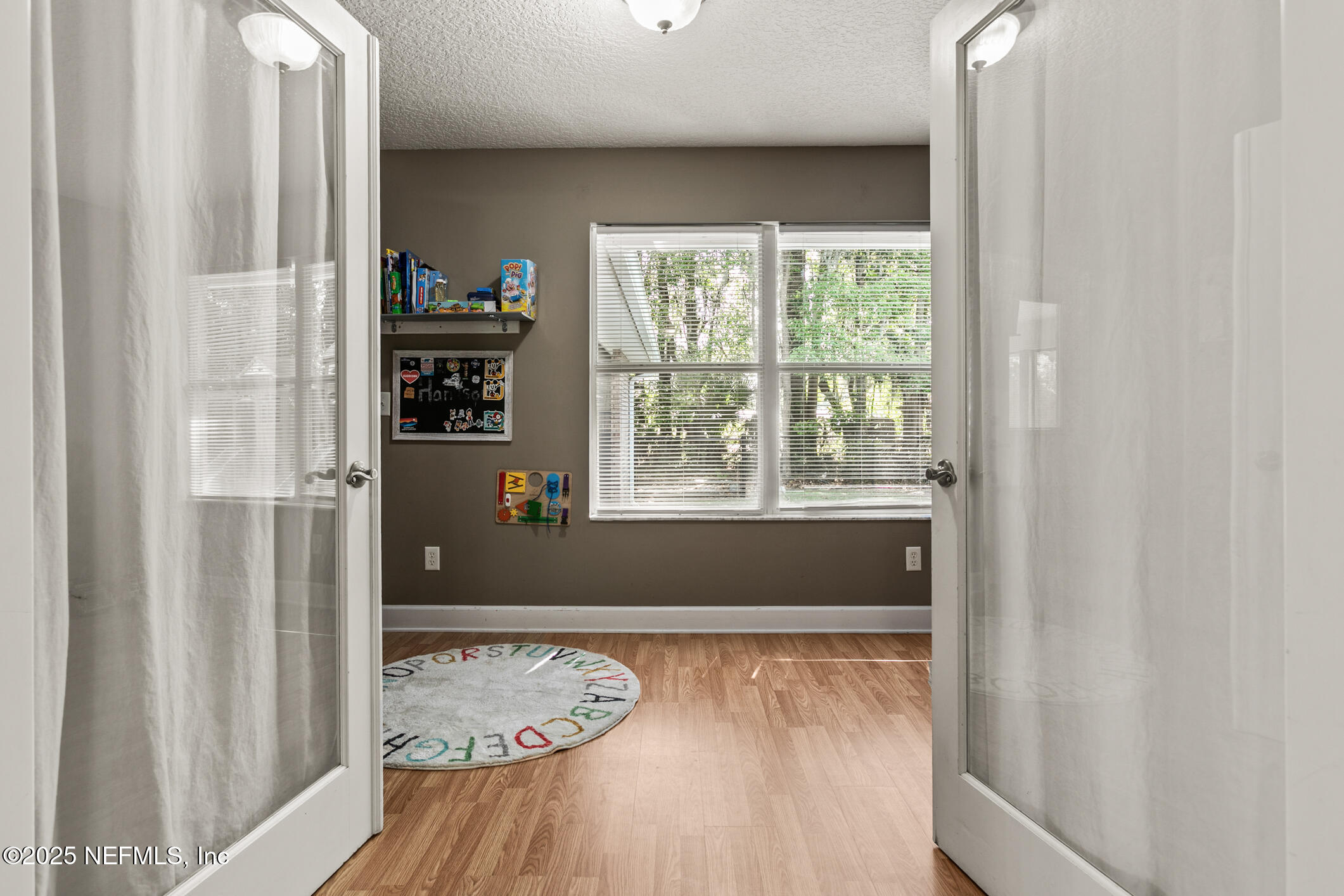 85 Murray Street North Baldwin, FL 32234 - Photo 11 of 49 a view of wooden floor and windows in a room