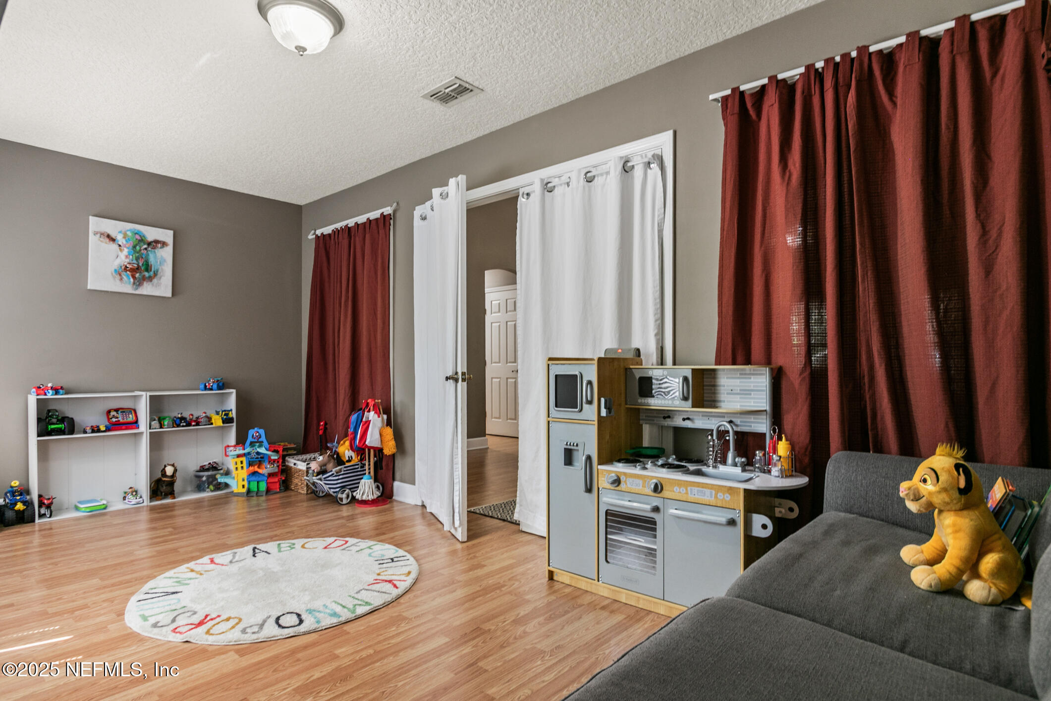 85 Murray Street North Baldwin, FL 32234 - Photo 12 of 49 a living room with furniture and a flat screen tv