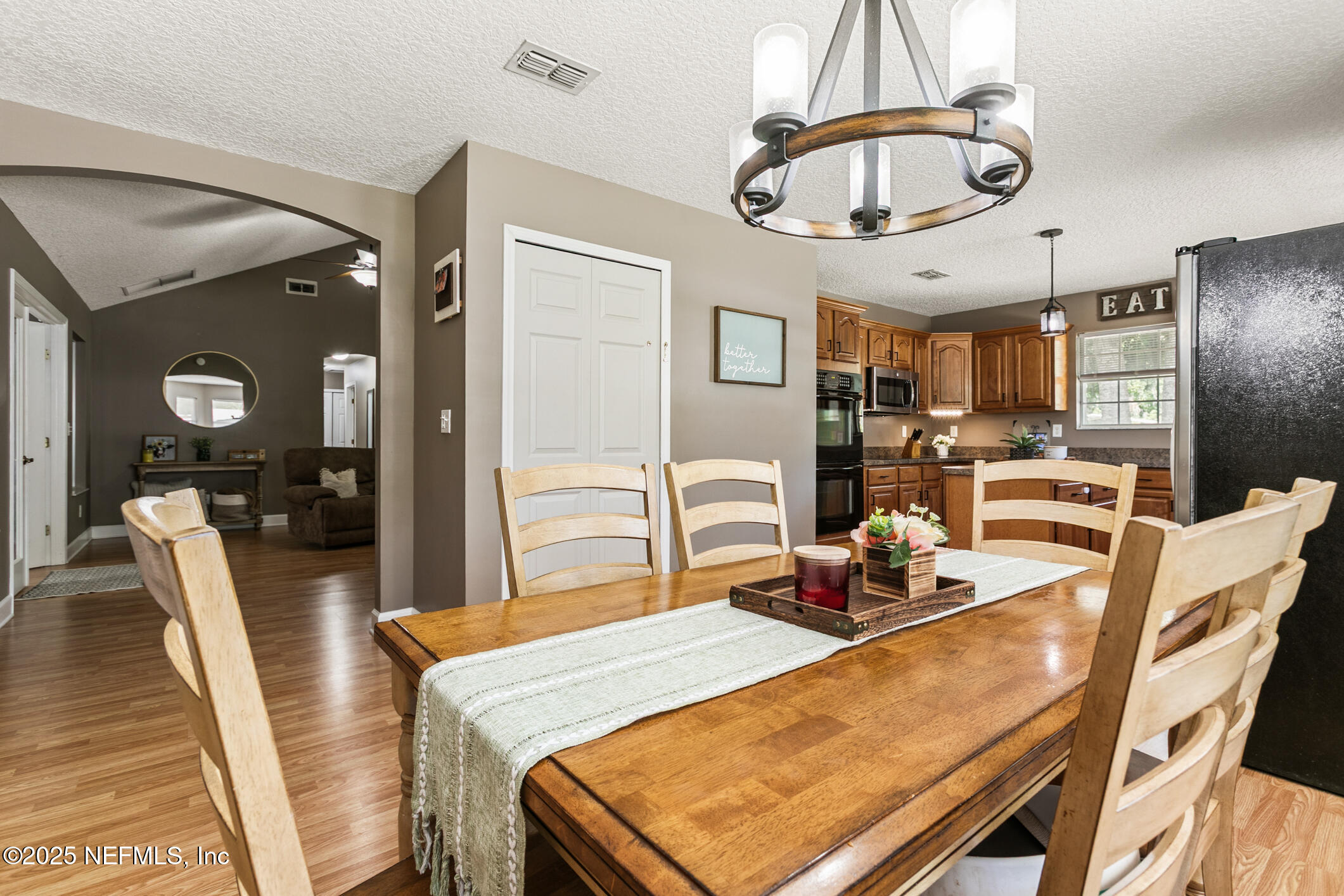 85 Murray Street North Baldwin, FL 32234 - Photo 16 of 49 a dining room with furniture a chandelier and wooden floor
