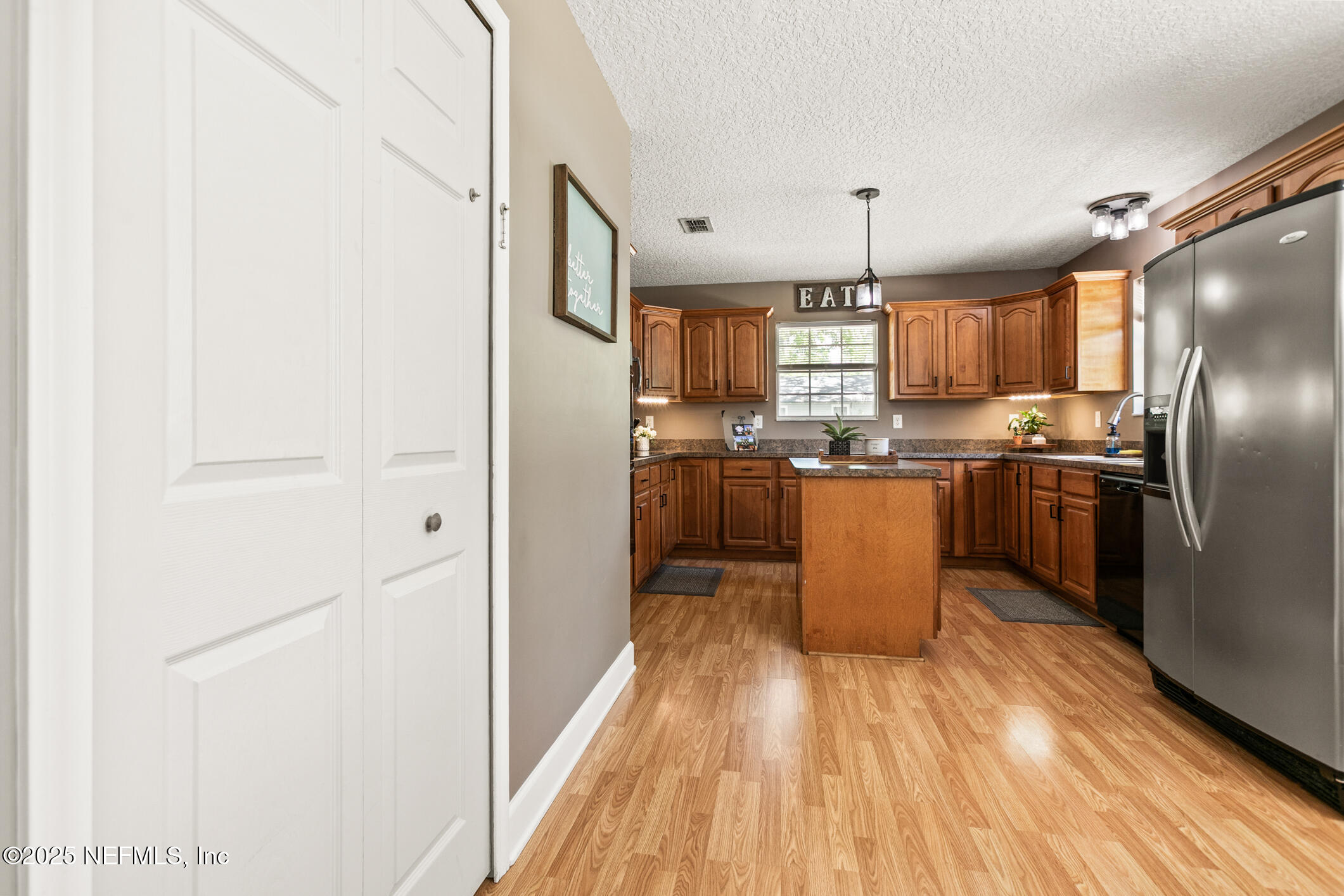 85 Murray Street North Baldwin, FL 32234 - Photo 17 of 49 a kitchen with stainless steel appliances granite countertop a refrigerator a sink dishwasher a stove with wooden cabinets and floor