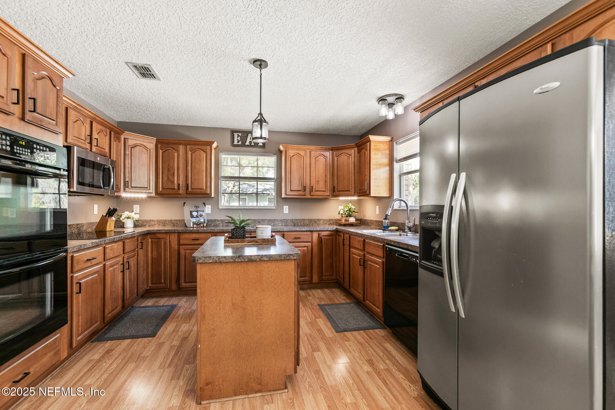 85 Murray Street North Baldwin, FL 32234 - Photo 18 of 49 a kitchen with granite countertop stainless steel appliances and wooden cabinets