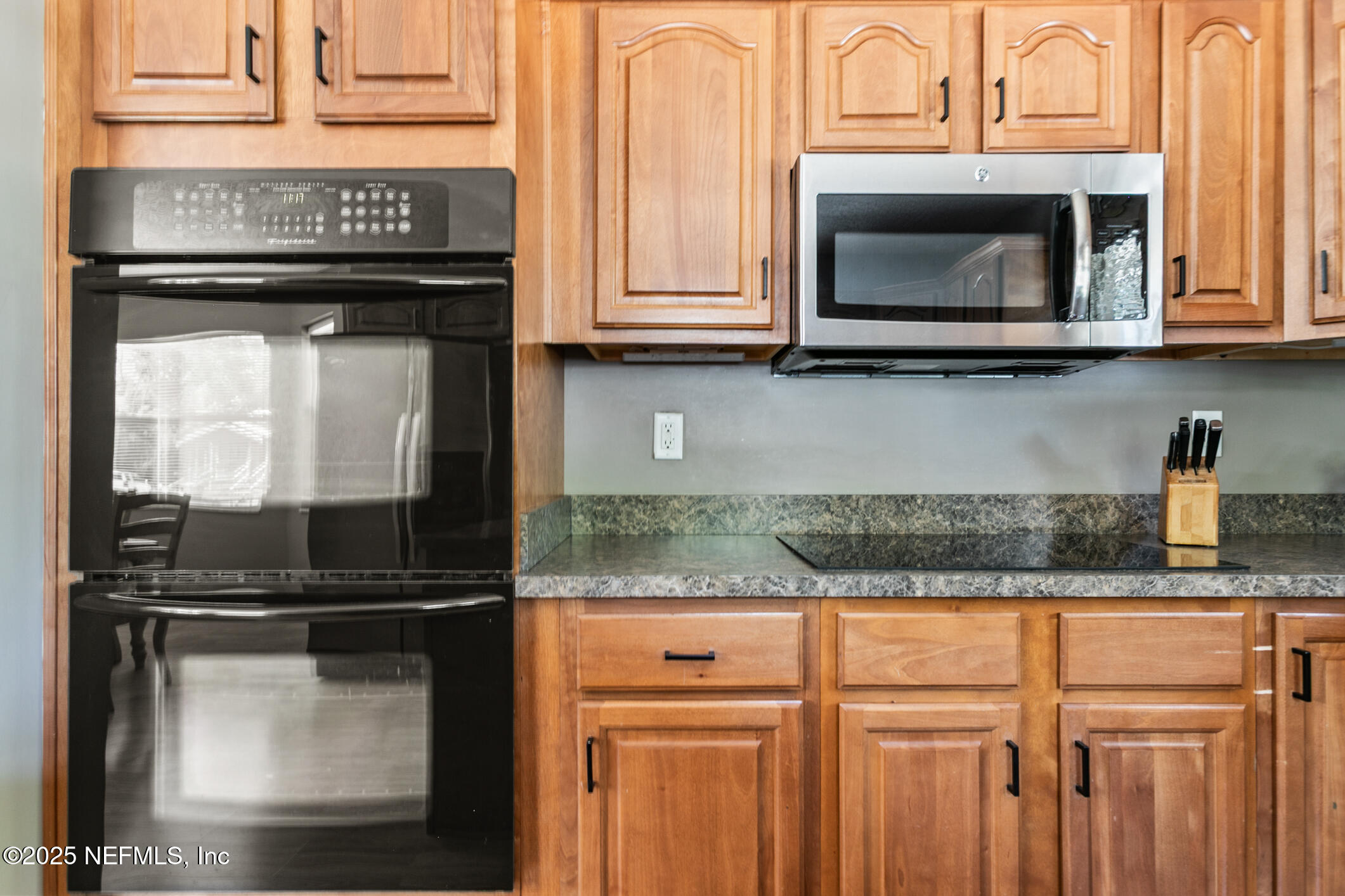 85 Murray Street North Baldwin, FL 32234 - Photo 20 of 49 a kitchen with granite countertop a stove microwave and sink