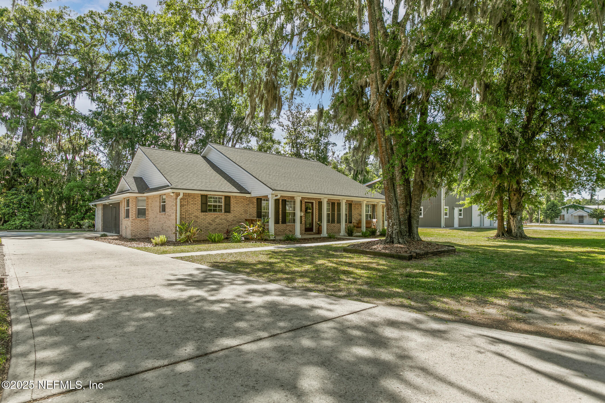 85 Murray Street North Baldwin, FL 32234 - Photo 2 of 49 a front view of a house with a garden