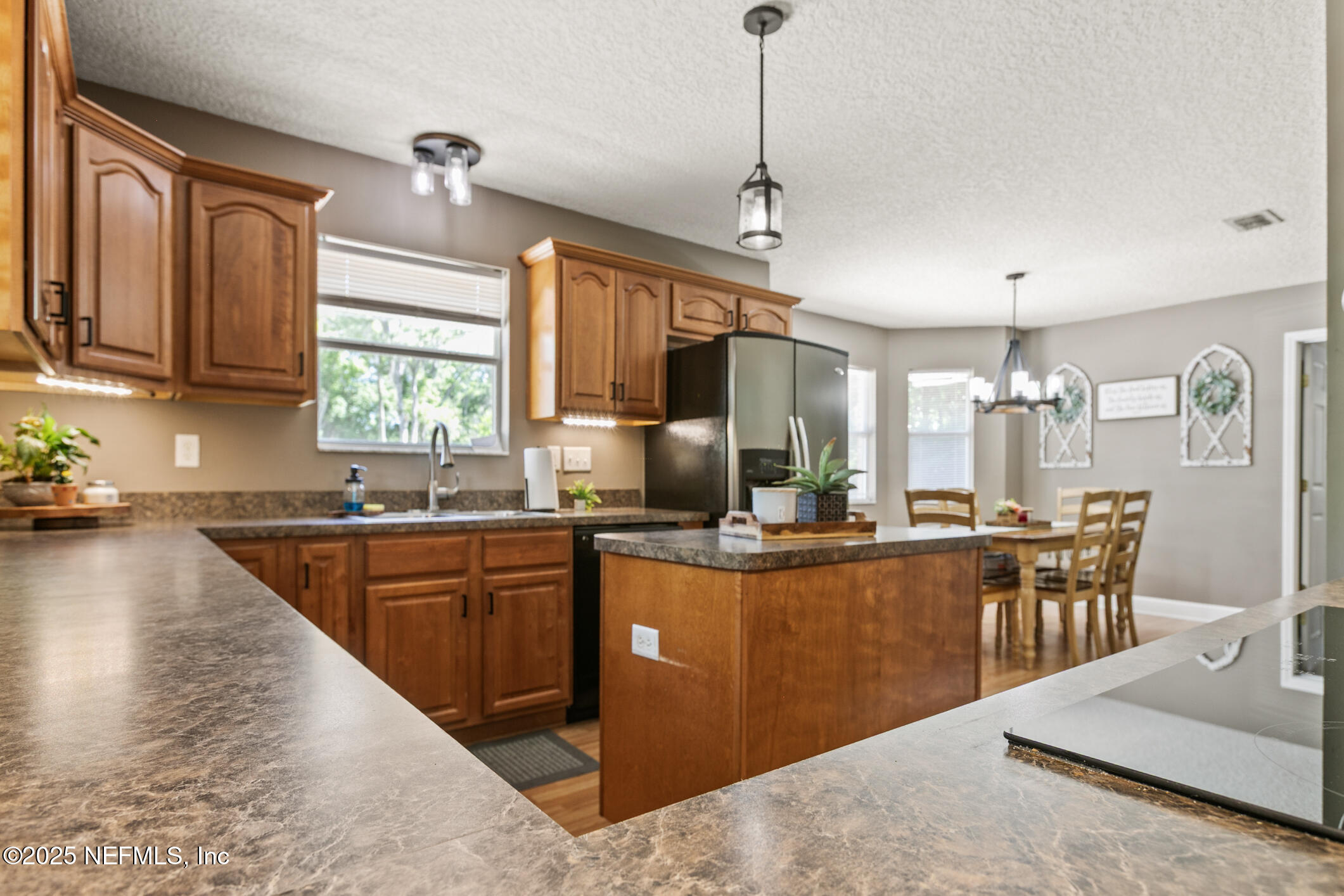 85 Murray Street North Baldwin, FL 32234 - Photo 21 of 49 a kitchen with lots of counter top space and dining table