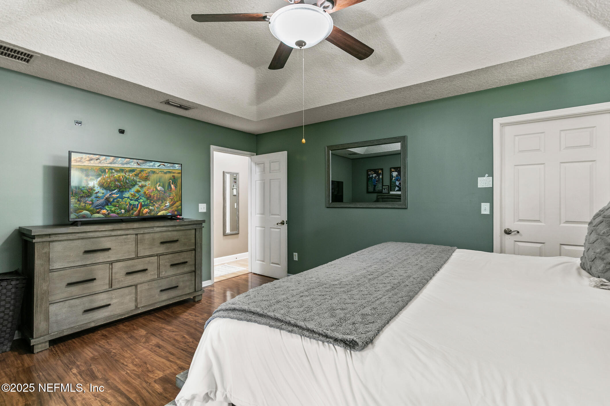 85 Murray Street North Baldwin, FL 32234 - Photo 24 of 49 a bedroom with a bed and a flat screen tv