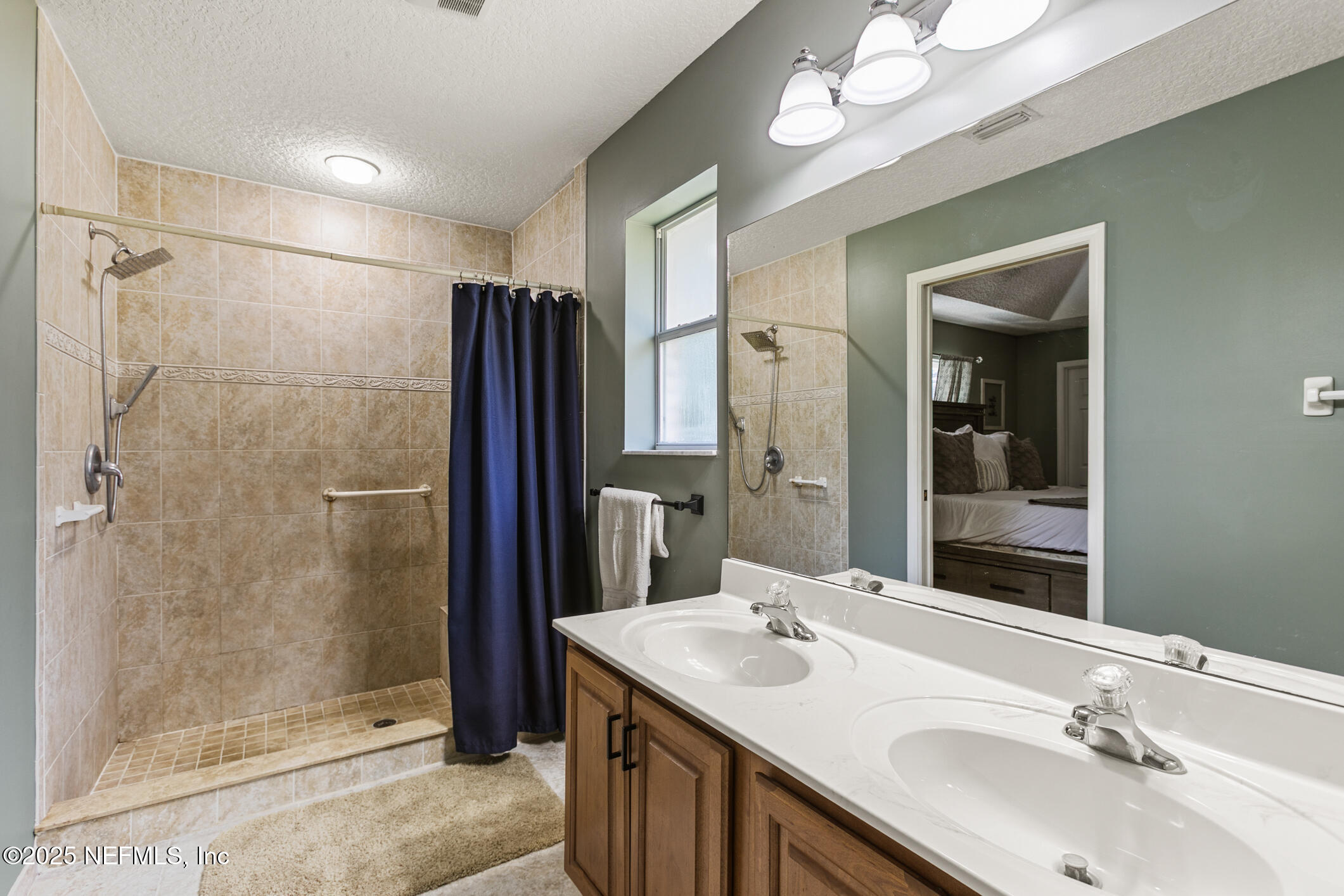 85 Murray Street North Baldwin, FL 32234 - Photo 25 of 49 a bathroom with a double vanity sink mirror and shower